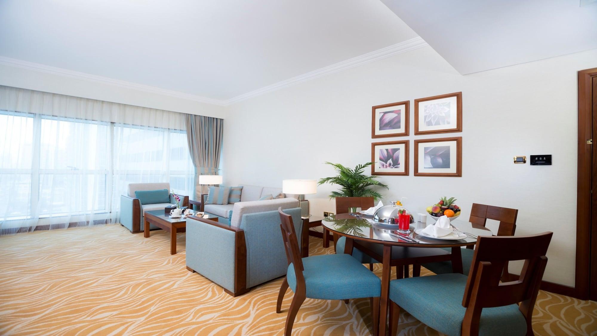 Grand Mercure Majlis Residences Abu Dhabi Bagian luar foto A living room in a suite at the Jumeirah Beach Hotel