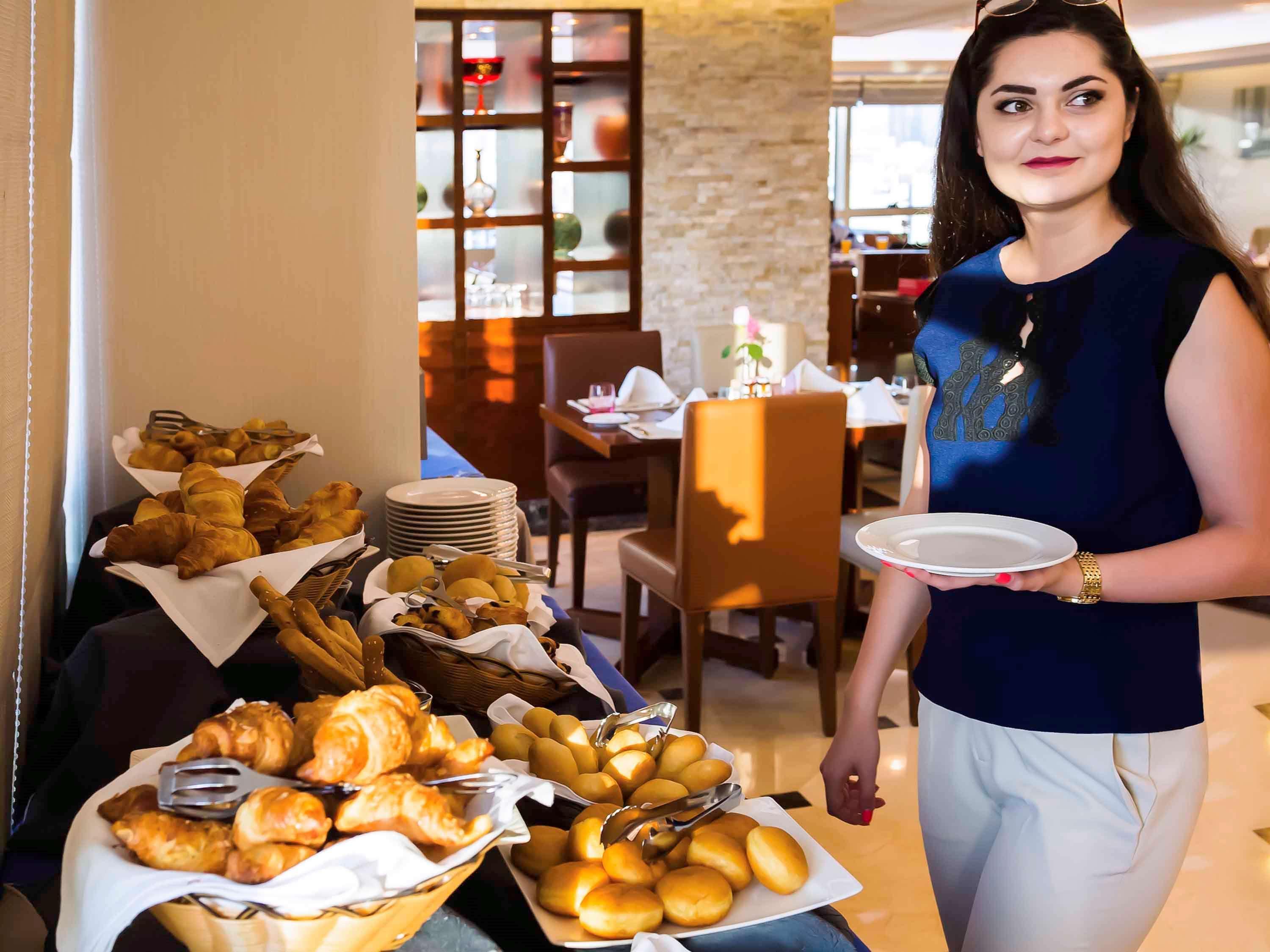 Grand Mercure Majlis Residences Abu Dhabi Bagian luar foto A hotel staff serving food